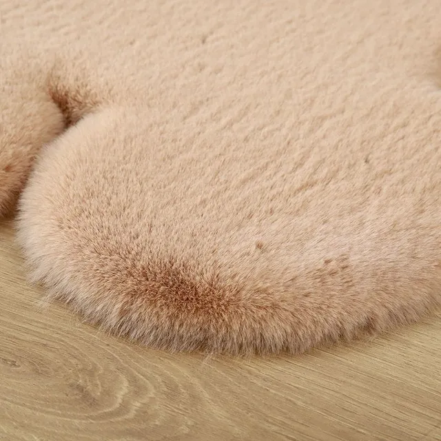 Soft rug in the shape of a teddy bear