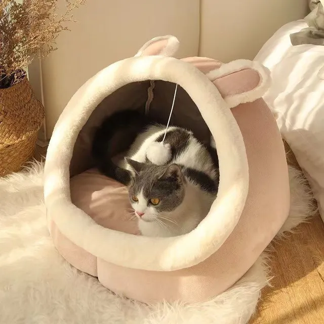 Cat bed in the shape of a house with a bed