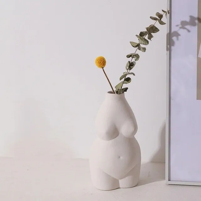 A decorative vase in the shape of a woman's body