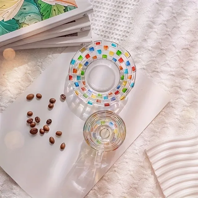 Set of coloured glass cups with saucers