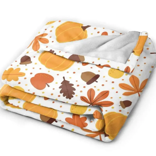 Autumn flannel blanket with a motif of pumpkins and leaves for sofa, bed or couch