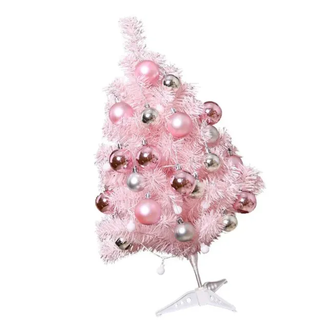 Set of cute Christmas tree on table in pink color and decorations