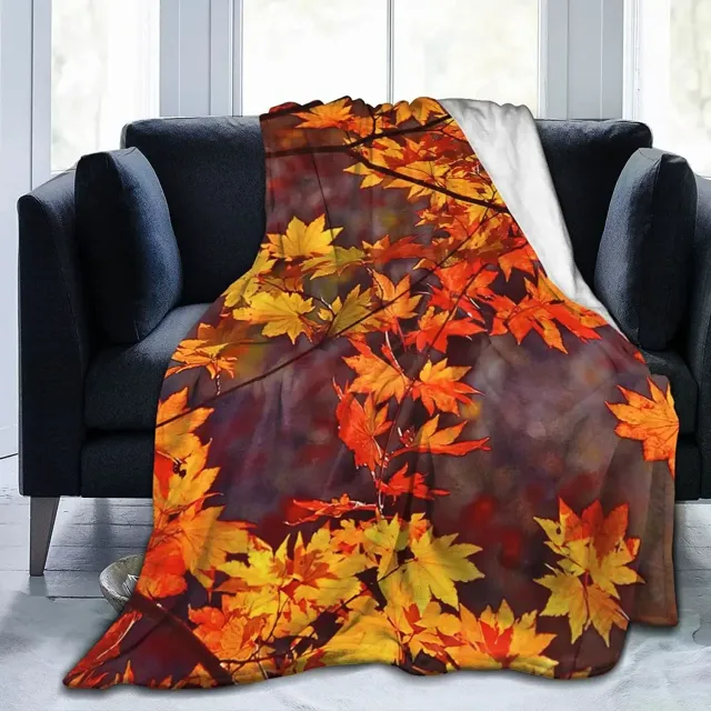 Autumn flannel blanket with a motif of pumpkins and leaves for sofa, bed or couch