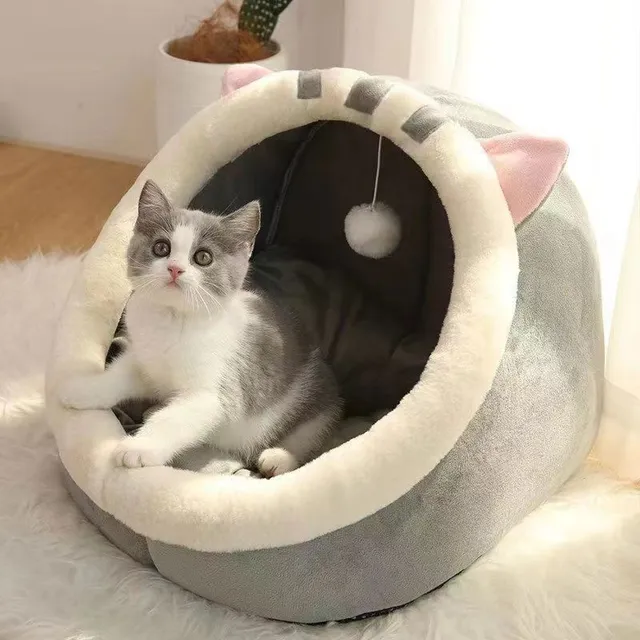 Cat bed in the shape of a house with a bed