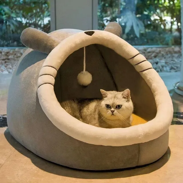 Cat bed in the shape of a house with a bed