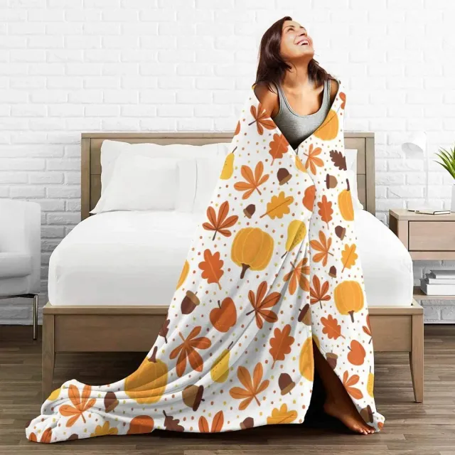 Autumn flannel blanket with a motif of pumpkins and leaves for sofa, bed or couch