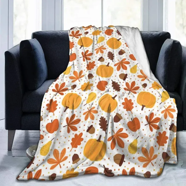 Autumn flannel blanket with a motif of pumpkins and leaves for sofa, bed or couch