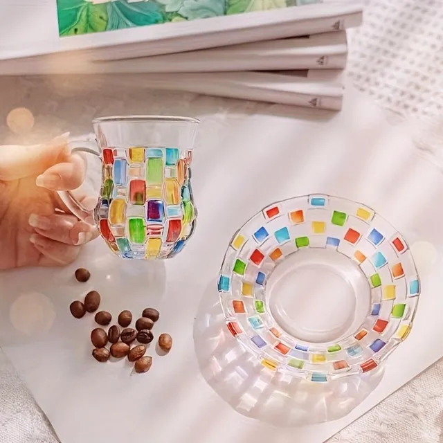 Set of coloured glass cups with saucers