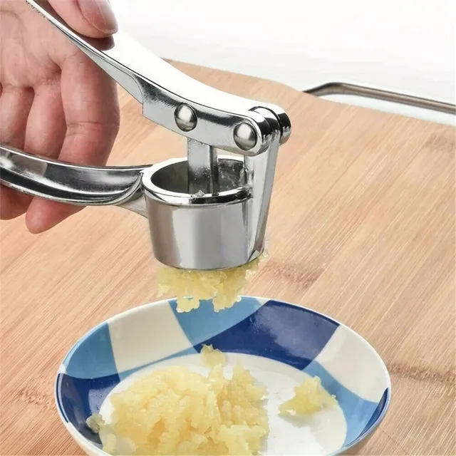 Hand-operated garlic and ginger press of metal