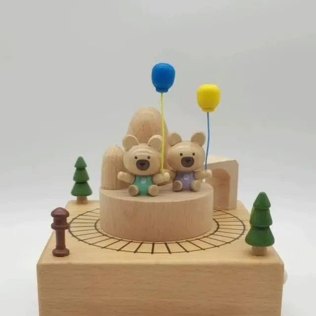 Wooden music box with rotating bears and train