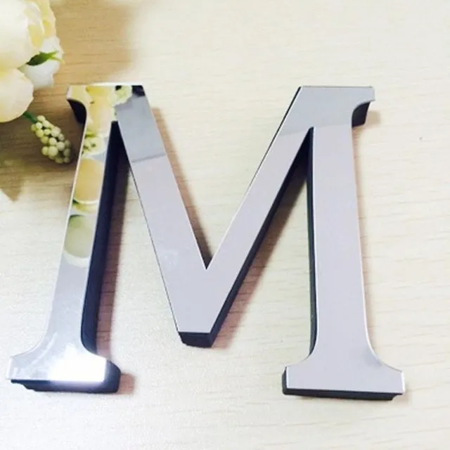 Stick-on mirror letters on the wall