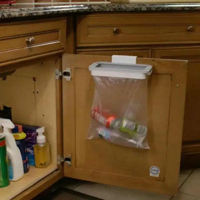 Holder for waste basket on the back of the kitchen cabinet door
