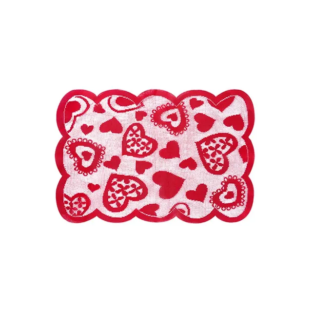 Czerwony bieżnik walentynkowy na stole z haftowanymi sercami