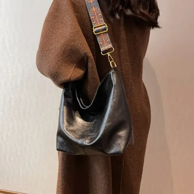 Vintage leather bag over shoulder with wide strap