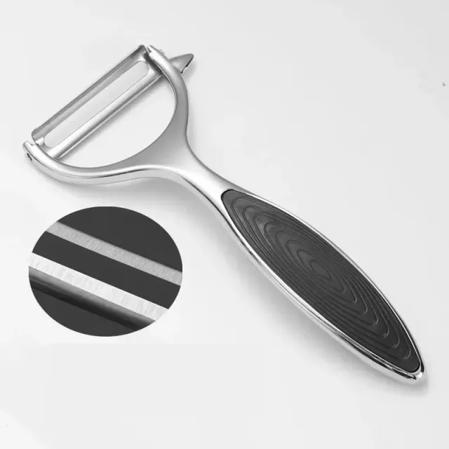 Stainless steel vegetable peeler with rubber holder