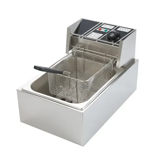 Electric fryer with basket and lid, kitchen fryer on work plate