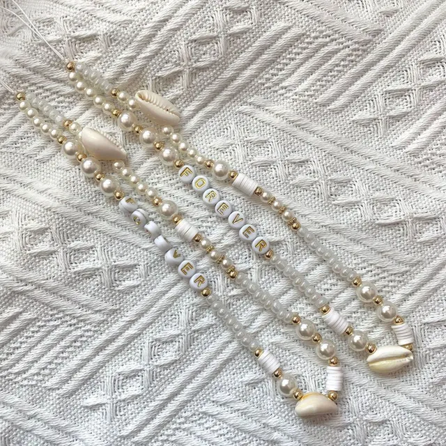 Joli pendentif de téléphone avec perles et coquillages