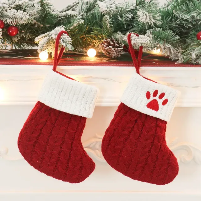 Cute stocking with Christmas motifs and knitted paw pattern
