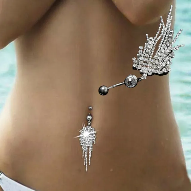 Silver piercing in the belly button with pendant