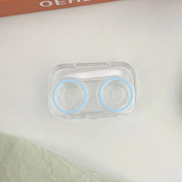 Miniature contact lens case made of clear plastic