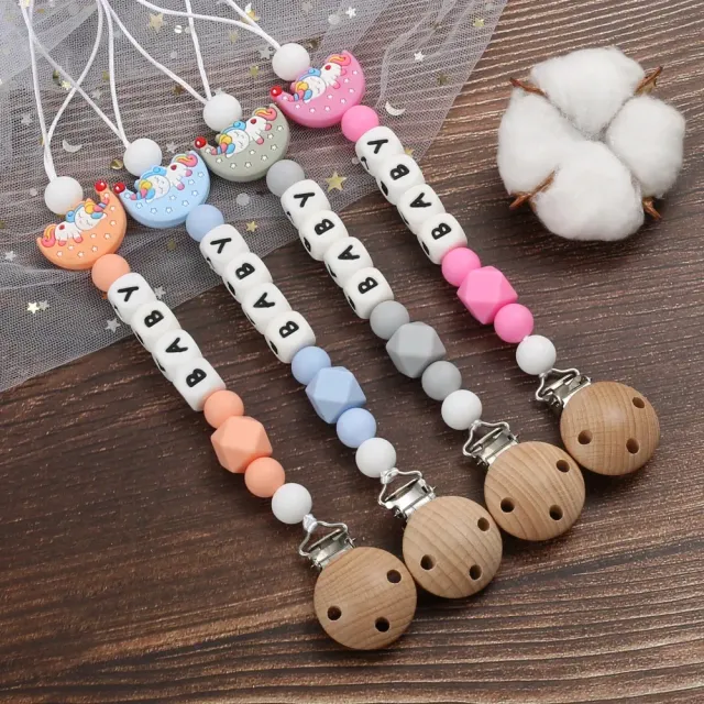 Silicone pacifier clip with motif of moon and bite