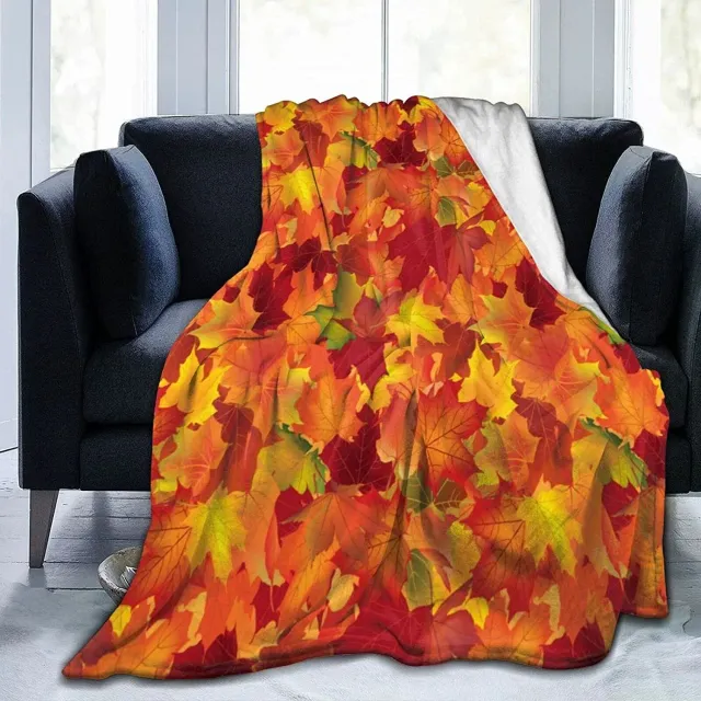 Autumn flannel blanket with a motif of pumpkins and leaves for sofa, bed or couch