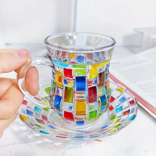 Set of coloured glass cups with saucers