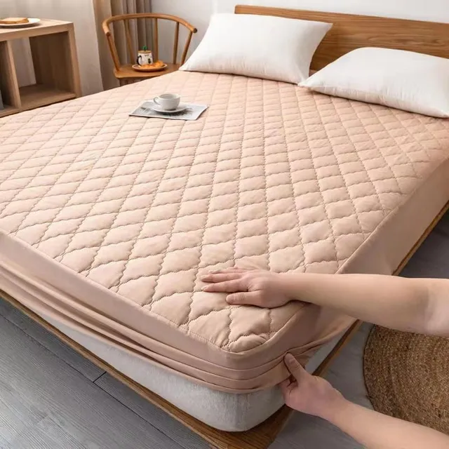 Waterproof mattress protector with rough padding and pleasant household fabric