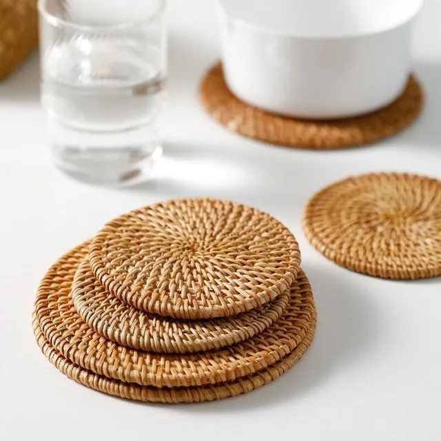 Modern knitted trendy favorite rattan coaster on the table under the cup