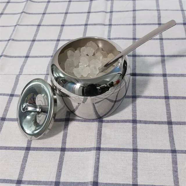 Stainless steel sugar with a spoonful of apple