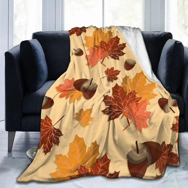 Autumn flannel blanket with a motif of pumpkins and leaves for sofa, bed or couch