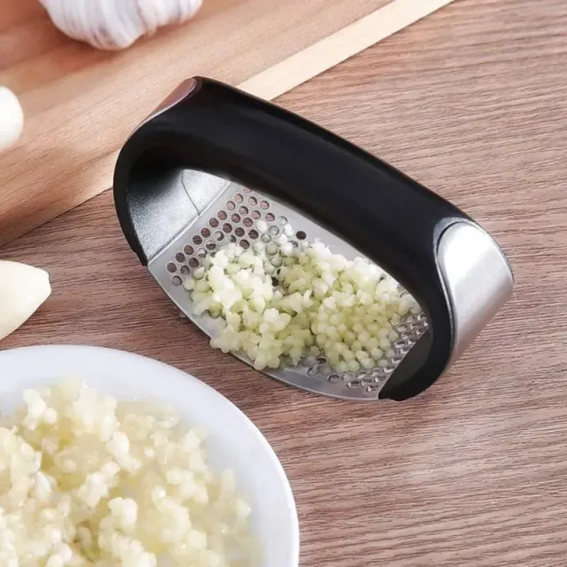 Hand-operated garlic press made of stainless steel