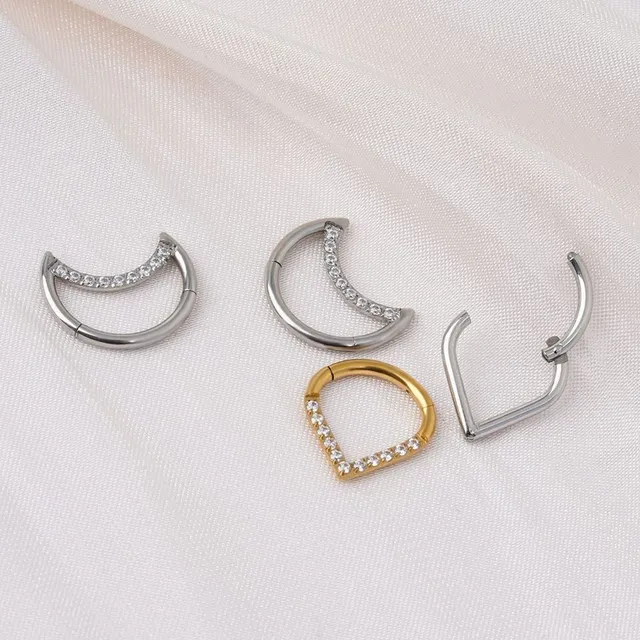 Trendy septum nose piercing in the shape of a teardrop or crescent