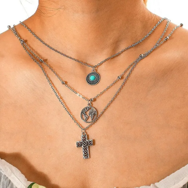 Female triple necklace with cross and globe