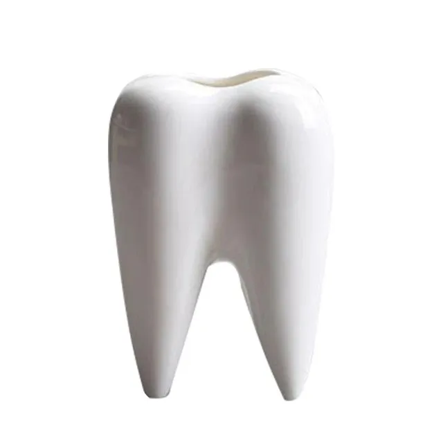 Decorative flower pot in the shape of a tooth