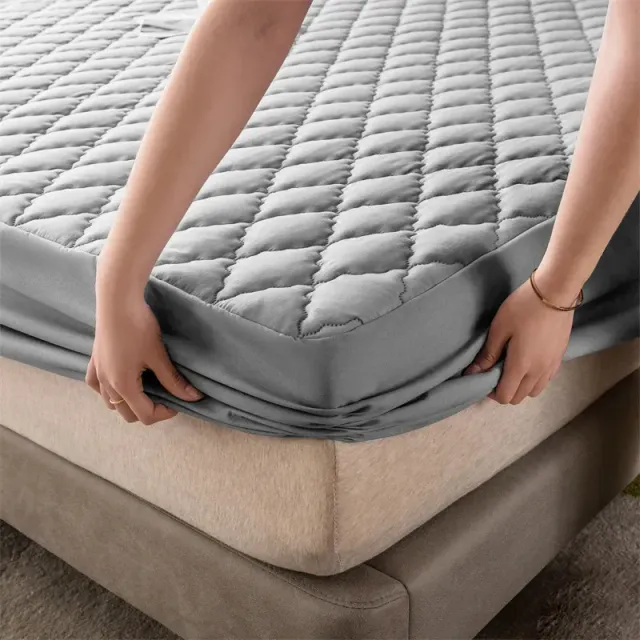 Waterproof mattress protector with rough padding and pleasant household fabric