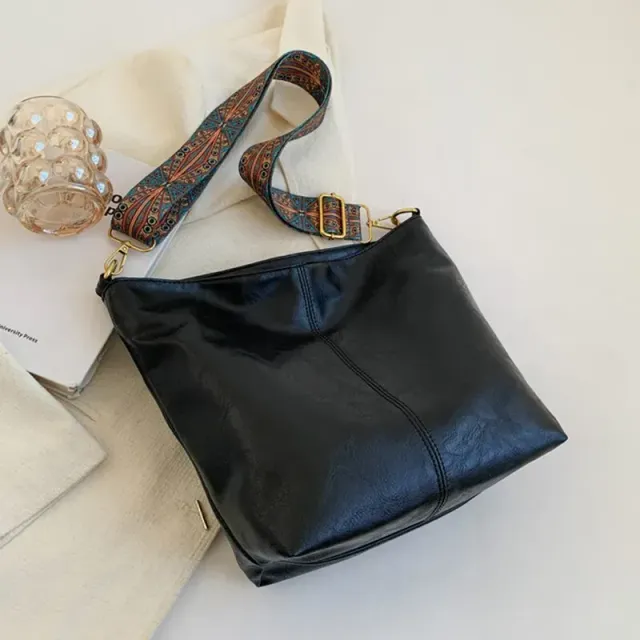 Vintage leather bag over shoulder with wide strap