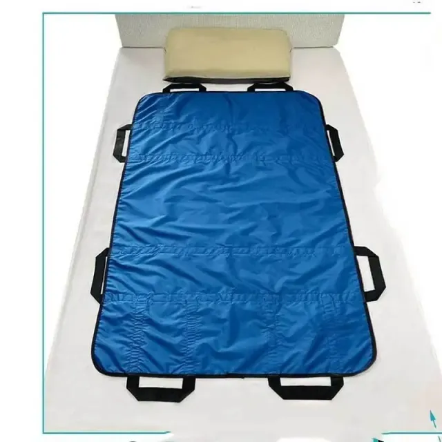 Insoluble bed positioning pad with reinforced handles