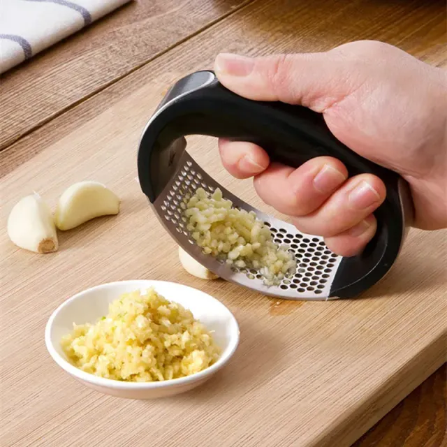 Stainless steel garlic press with simple surface cleaning © Ideal kitchen helper for garlic lovers