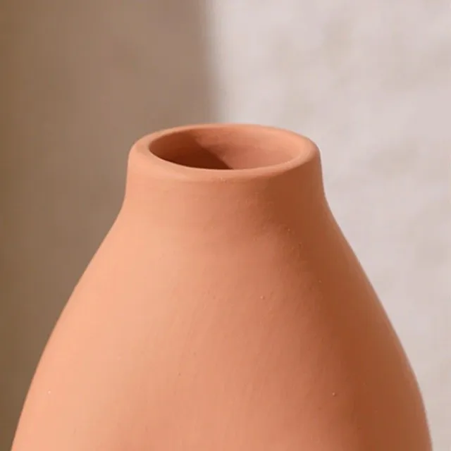 A decorative vase in the shape of a woman's body