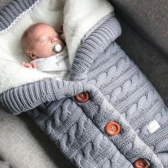 Knitted fusak with buttons in the stroller seda