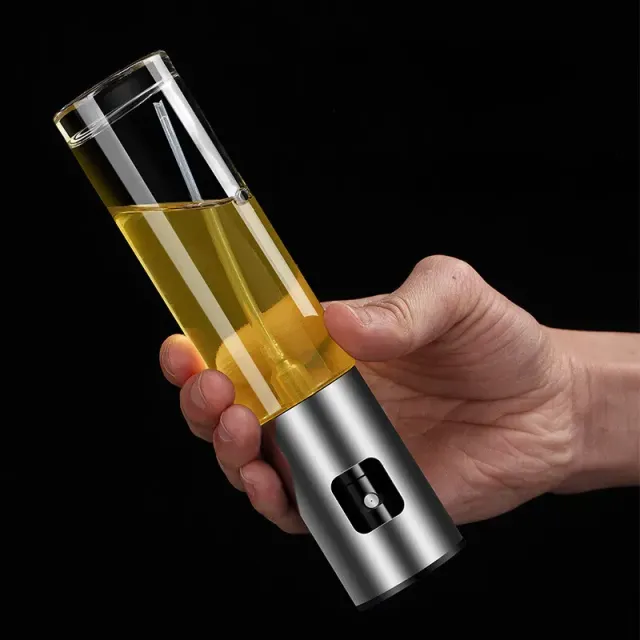 Olive oil sprayer and vinegar in a glass bottle