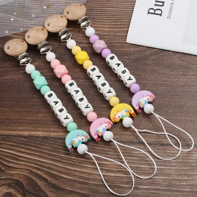 Silicone pacifier clip with motif of moon and bite