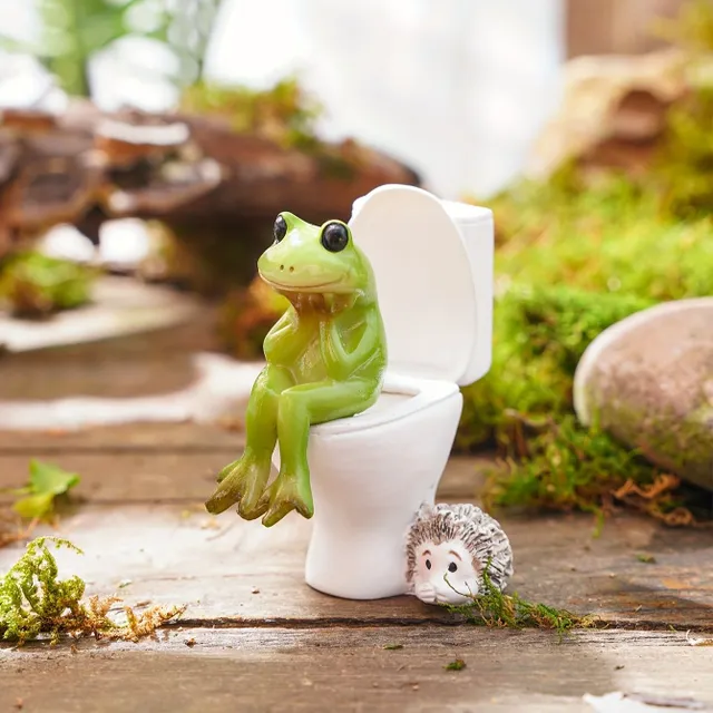 A whimsical frog statue in a resin toilet