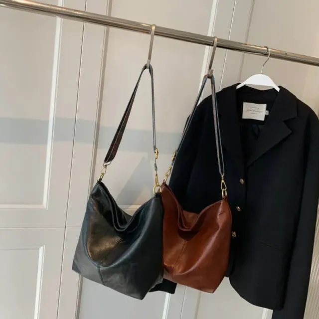 Vintage leather bag over shoulder with wide strap