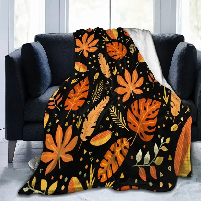 Autumn flannel blanket with a motif of pumpkins and leaves for sofa, bed or couch