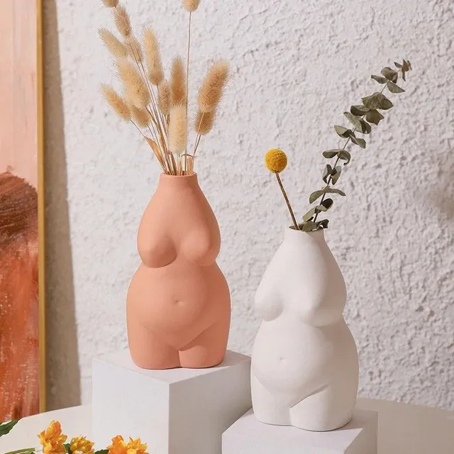 A decorative vase in the shape of a woman's body