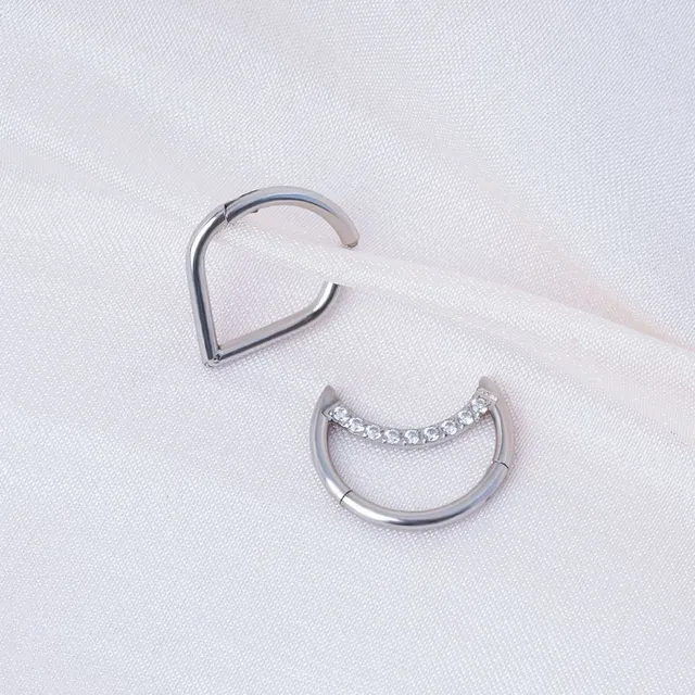 Trendy septum nose piercing in the shape of a teardrop or crescent