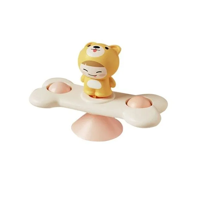 Rotating toy with suction cup