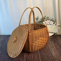 Picnic basket of rustic appearance made of knitted plastic with handles - durable and light for camping and meeting